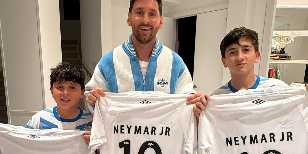 Messi e os filhos com a camisa autografada enviada pelo amigo e ex-parceiro de clube, Neymar