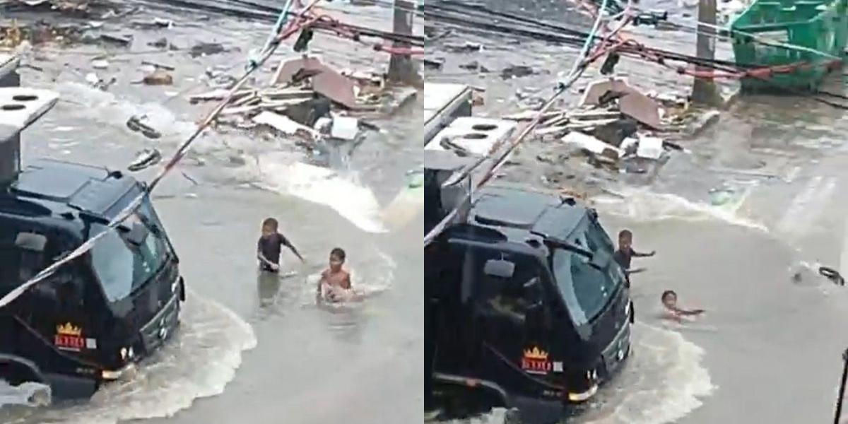 Crianças são arrastadas por enxurrada ao tentar “pegar onda” de caminhão em cruzamento de Guarujá, no litoral de São Paulo; VÍDEO