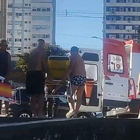 Ambulante idoso foi levado por banhistas em cadeira de praia até a ambulância enquanto equipe do Samu aguardava na avenida da orla, no Gonzaguinha, em São Vicente