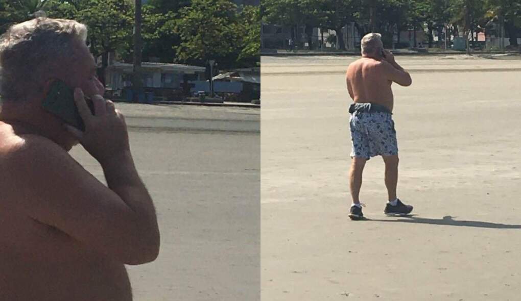 Sem camisa e falando ao celular, magistrado foi flagrado novamente sem máscara na praia